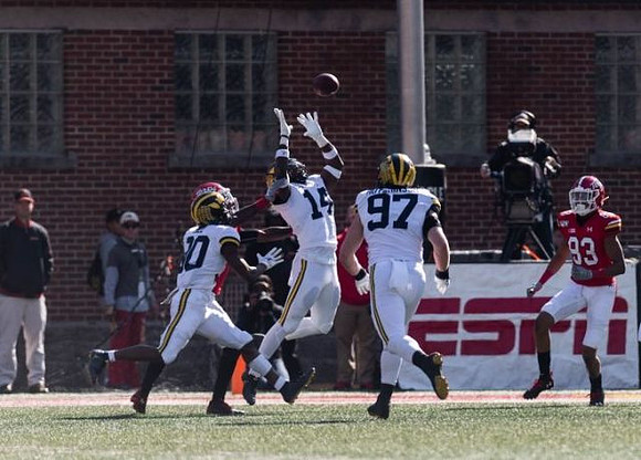 Brad Hawkins (20), Josh Metellus (14), and Aidan Hutchinson (97)
