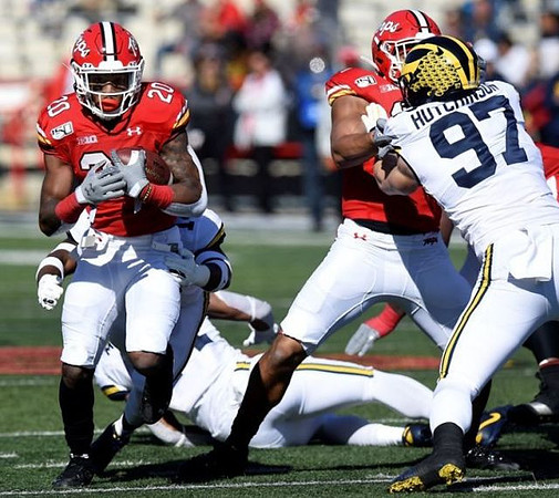 Josh Metellus (14) and Aidan Hutchinson (97)