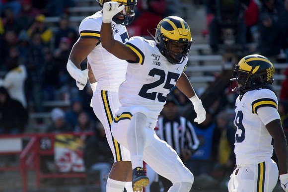 Tarik Black (7), Hassan Haskins (25), and Mike Sainristil (19)