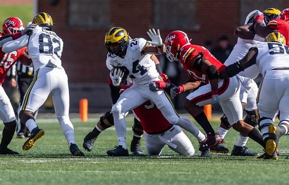 Nick Eubanks (82), Zach Charbonnet (24), and Michael Onwenu (50)