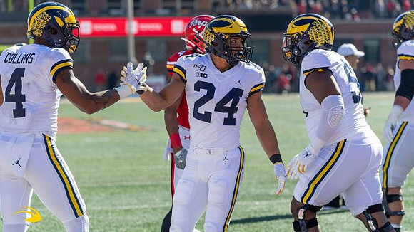 Nico Collins (4), Zach Charbonnet (24), and Michael Onwenu (50)