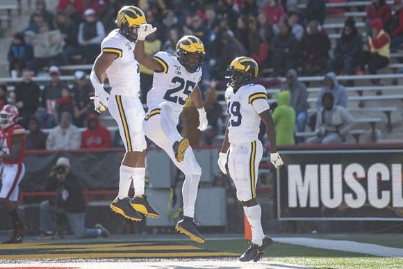 Tarik Black (7), Hassan Haskins (25), and Mike Sainristil (19)