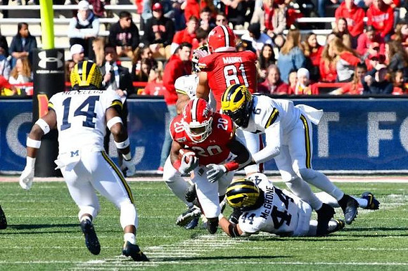 Josh Metellus (14), Cameron McGrone (44), and Josh Uche (6)