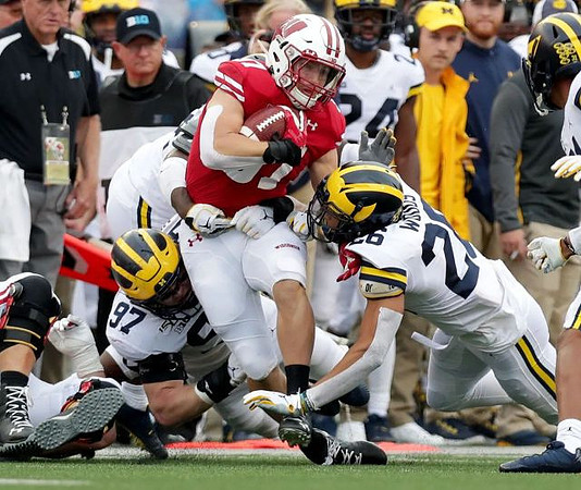 Aidan Hutchinson (97) and J'Marick Woods (26)