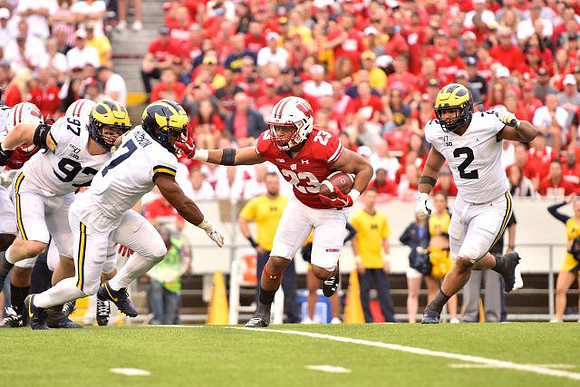 Aidan Hutchinson (97), Khaleke Hudson (7), and Carlo Kemp (2)