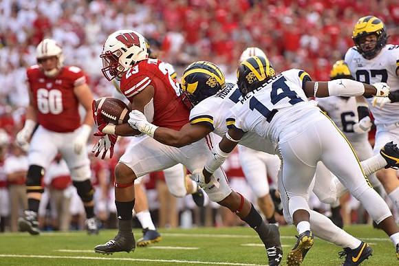Khaleke Hudson (7), Josh Metellus (14), Josh Uche (6), and Aidan Hutchinson (97)