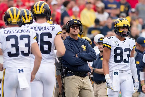 Camaron Cheeseman (33), Luke Schoonmaker (86), Jim Harbaugh, and Erick All (83)