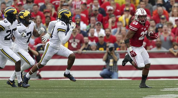 Brad Hawkins (20), Khaleke Hudson (7), and Vincent Gray (31)