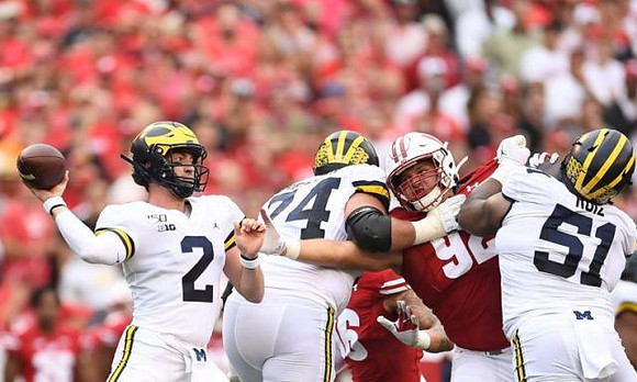 Shea Patterson (2), Ben Bredeson (74), and Cesar Ruiz (51)