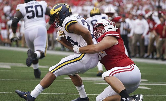 Michael Onwenu (50) and Zach Charbonnet (24)