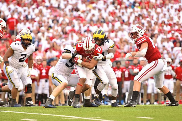 Carlo Kemp (2), Aidan Hutchinson (97), and Josh Metellus (14)