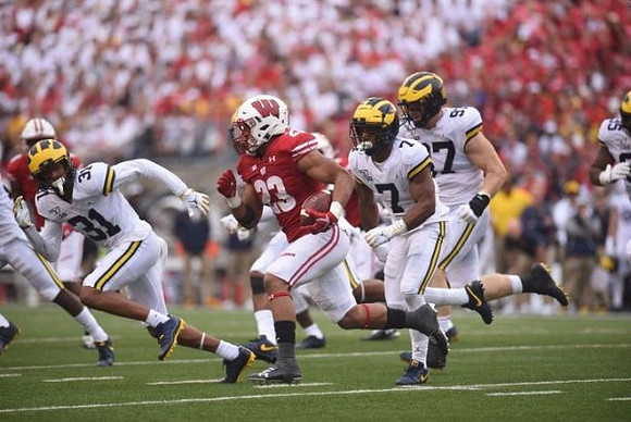 Vincent Gray (31), Khaleke Hudson (7), and Aidan Hutchinson (97)
