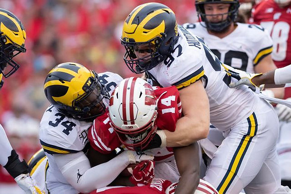 Jordan Anthony (34) and Aidan Hutchinson (97)