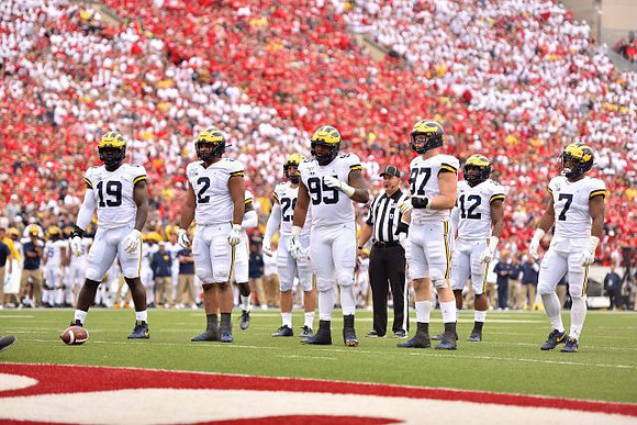 Kwity Paye (19), Carlo Kemp (2), Jordan Glasgow (29), Donovan Jeter (95), Aidan Hutchinson (97), Josh Ross (12), and Khaleke Hudson (7)