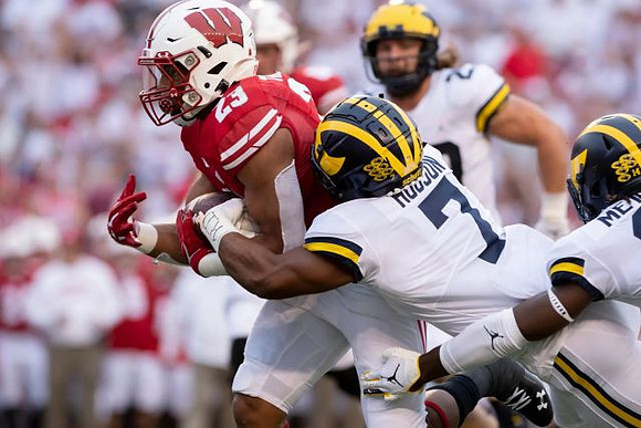 Khaleke Hudson (7), Jordan Glasgow (29), and Josh Metellus (14)