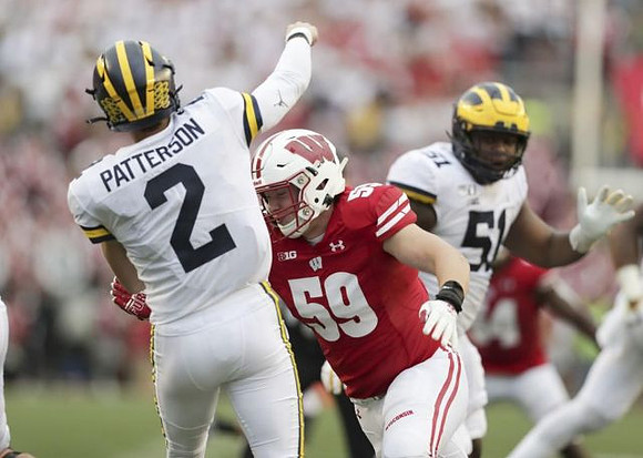 Shea Patterson (2) and Cesar Ruiz (51)