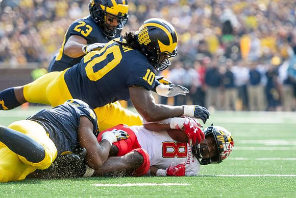 Josh Uche (6), Devin Bush (10), and Tyree Kinnel (23)