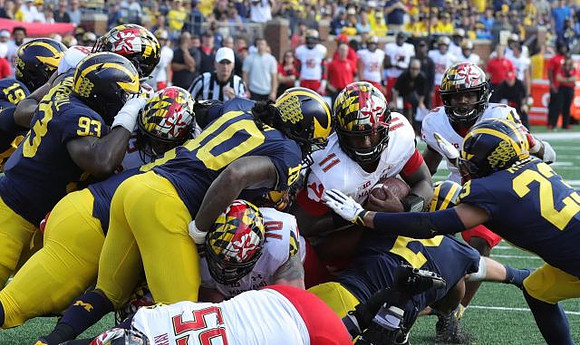 Kwity Paye (19), Lawrence Marshall (93), Devin Bush (10), Carlo Kemp (2), and Tyree Kinnel (23)