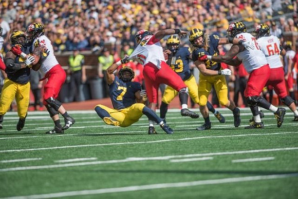Khaleke Hudson (7), Lawrence Marshall (93), and Chase Winovich (15)