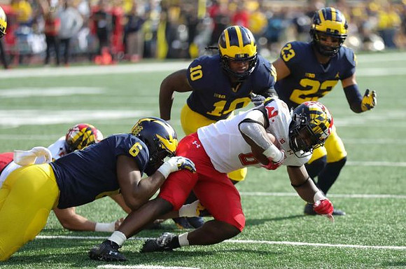 Josh Uche (6), Devin Bush (10), and Tyree Kinnel (23)