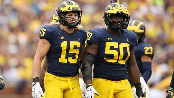 Chase Winovich (15), Michael Dwumfour (50), and Tyree Kinnel (23)