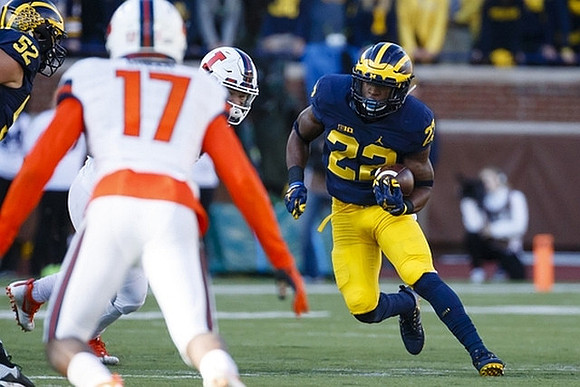 Mason Cole (52) and Karan Higdon (22)
