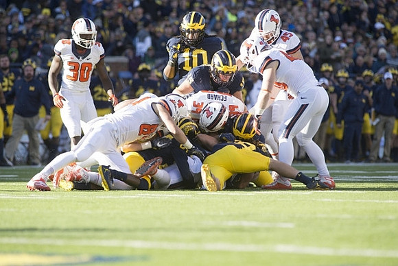 Devin Bush (10) and Chase Winovich (15)
