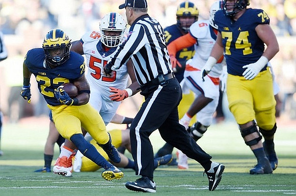Karan Higdon (22), Ben Braden (71), and Ben Bredeson (74)