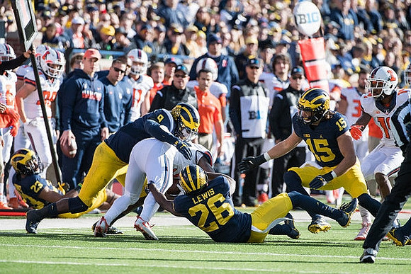 Tyree Kinnel (23), Mike McCray (9), Jourdan Lewis (26), and Chase Winovich (15)