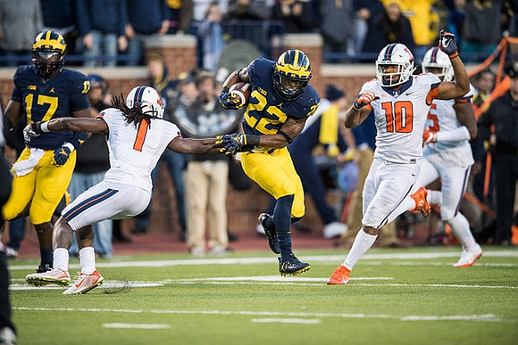 Tyrone Wheatley Jr. (17) and Karan Higdon (22)
