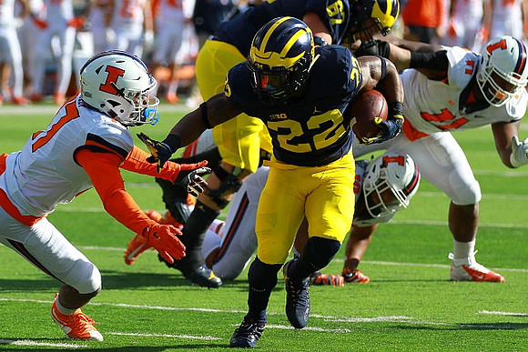 Karan Higdon (22) and Kyle Kalis (67)