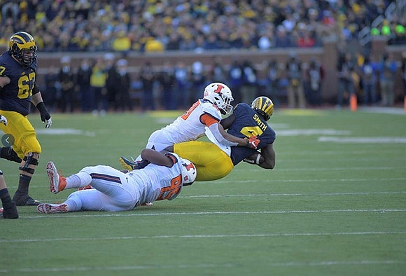 Kyle Kalis (67) and De'Veon Smith (4)