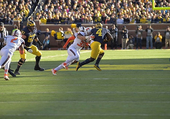 Kyle Kalis (67) and De'Veon Smith (4)