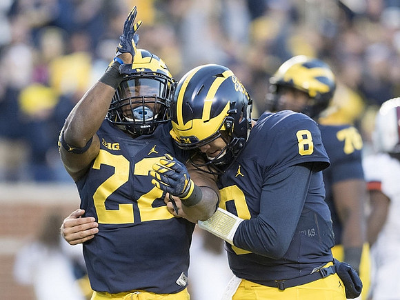 Karan Higdon (22) and John O'Korn (8)