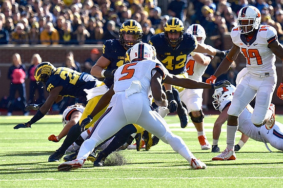 Dymonte Thomas (25), Chase Winovich (15), and Ben Gedeon (42)