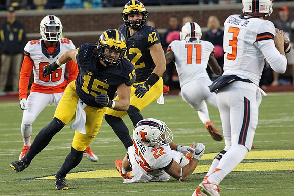 Chase Winovich (15) and Ben Gedeon (42)