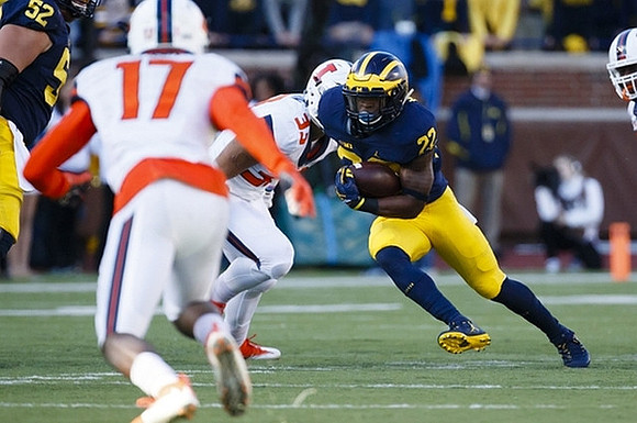 Mason Cole (52) and Karan Higdon (22)
