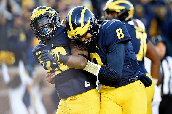Karan Higdon (22) and John O'Korn (8)
