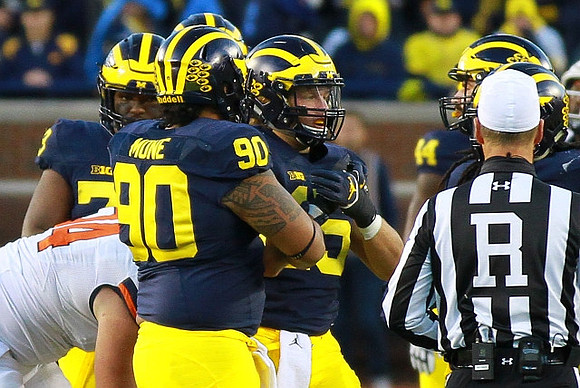 Maurice Hurst (73), Bryan Mone (90), Chase Winovich (15), and Delano Hill (44)