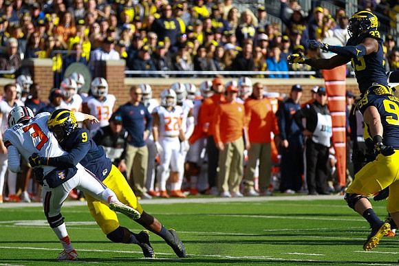 Mike McCray (9), Taco Charlton (33), and Matthew Godin (99)