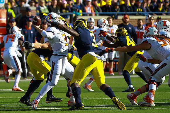 Rashan Gary (3) and Delano Hill (44)