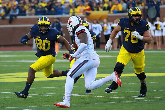 Khalid Hill (80), Karan Higdon (22), and Erik Magnuson (78)
