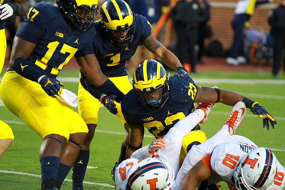 Tyrone Wheatley Jr. (17), Kekoa Crawford (1), and Tyree Kinnel (23)