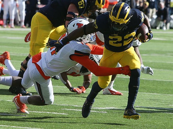 Kyle Kalis (67) and Karan Higdon (22)