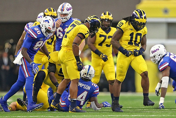 Khaleke Hudson (7), Maurice Hurst (73), and Devin Bush (10)