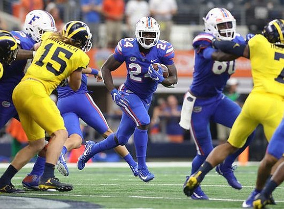 Chase Winovich (15) and Khaleke Hudson (7)
