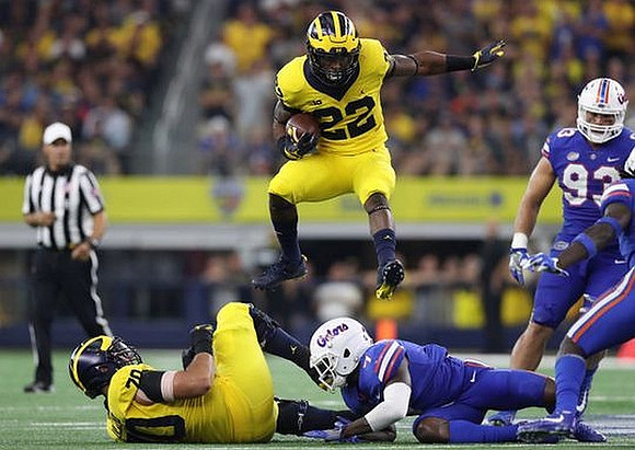 Nolan Ulizio (70) and Karan Higdon (22)