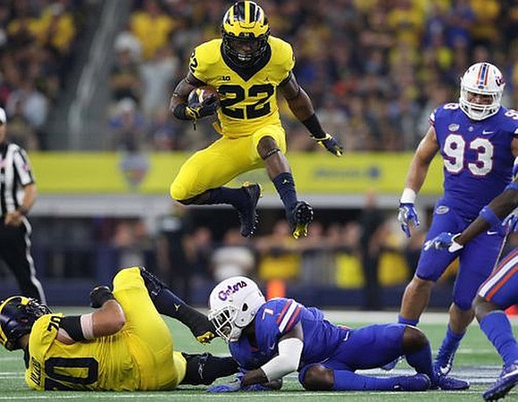 Nolan Ulizio (70) and Karan Higdon (22)
