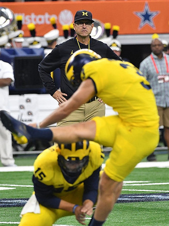 Jim Harbaugh, Garrett Moores (15), and Quinn Nordin (3)
