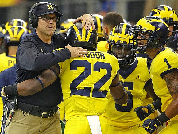 Jim Harbaugh, Karan Higdon (22), and Kekoa Crawford (1)